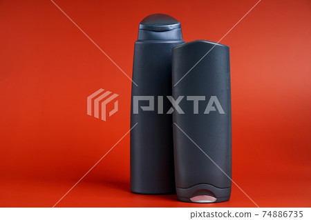 Two blank dark plastic container of shower gel or shampoo Two blank dark plastic container of shower gel or shampoo 74886735