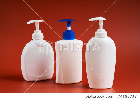 Set of three clean white plastic bottles with soap dispenser Set of three clean white plastic bottles with soap dispenser 74886738