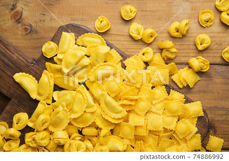 Tartollini with cheese or meat for cooking in broth, different shapes. Traditional dish for 74886992