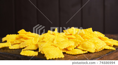 Small ravioli with cheese or meat to cook in broth, a traditional dish for celebrations in italy Small ravioli with cheese or meat to cook in broth, a traditional dish for celebrations in italy 74886994