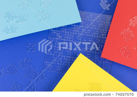 Transparent puzzle details on the color paper background. 74887070