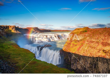 Gullfoss waterfall and the Olfusa river in southwest Iceland with a rainbow Gullfoss waterfall and the Olfusa river in southwest Iceland with a rainbow 74887107