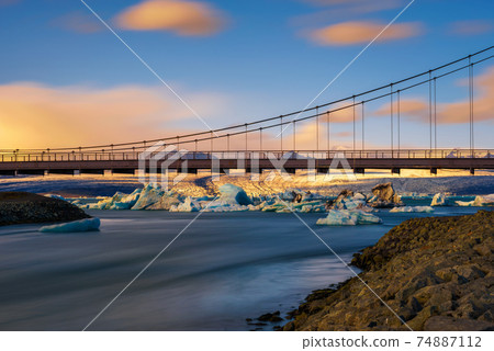 Road bridge over Jokulsarlon glacier lagoon in Iceland at sunset 74887112