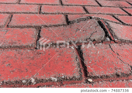 Red brick sidewalk requiring repair 74887336
