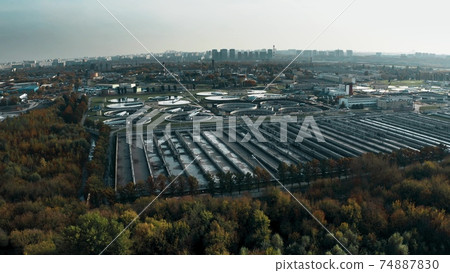 Aerial shot of a wastewater treatment plant and distant skyline. Big city waste processing concept Aerial shot of a wastewater treatment plant and distant skyline. Big city waste processing concept 74887830
