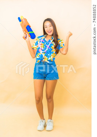 Portrait beautiful young asian wear colorful shirt for songkran festival Portrait beautiful young asian wear colorful shirt for songkran festival 74888852
