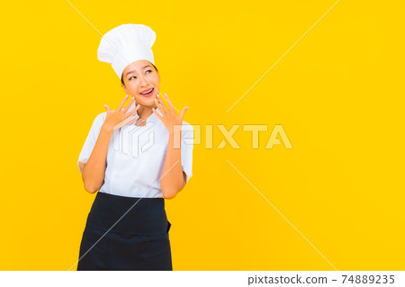 Portrait beautiful young asian woman in chef or cook uniform with hat 74889235