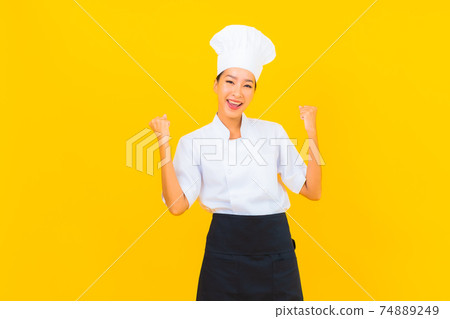 Portrait beautiful young asian woman in chef or cook uniform with hat 74889249