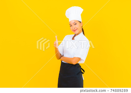 Portrait beautiful young asian woman in chef or cook uniform with hat 74889289
