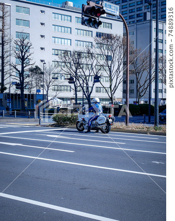 Police motorcycle of the Metropolitan Police Department patrols Kasumigaseki Police motorcycle of the Metropolitan Police Department patrols Kasumigaseki 74889316