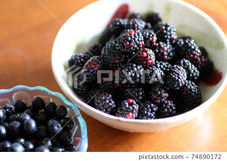Blackberries and blueberries on the table Blackberries and blueberries on the table 74890172