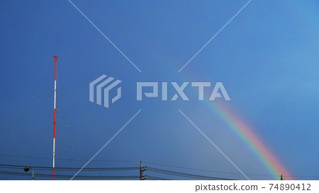 Scenery of the sky with a rainbow 74890412