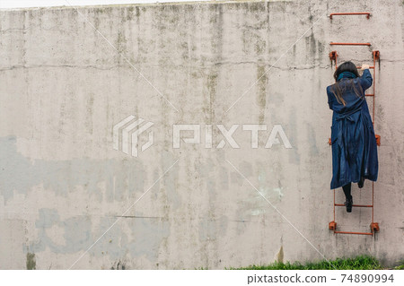 Back view of a woman climbing a ladder (whole body) 74890994