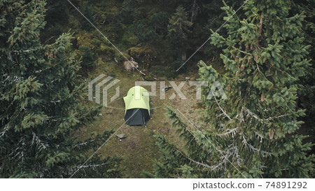 Closeup tent at pine trees forest aerial. Autumn nobody nature landscape. Pavilion at mountain wood Closeup tent at pine trees forest aerial. Autumn nobody nature landscape. Pavilion at mountain wood 74891292