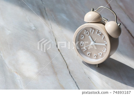 Alarm clock and copy space on marble background Alarm clock and copy space on marble background 74893187