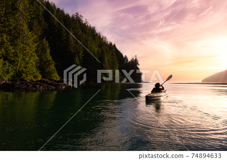 Adventurous Girl kayaking in the Pacific Ocean. 74894633