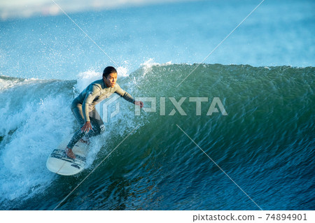 A man surfing in the Shonan sea 74894901