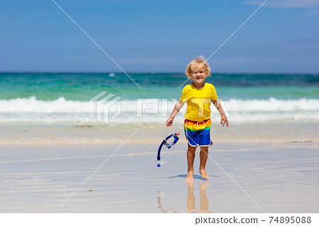 Child snorkeling on tropical beach. Kids snorkel. 74895088