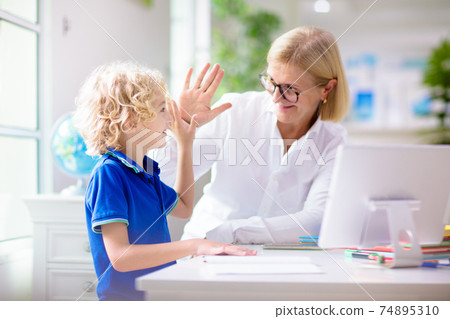 Online remote learning. School kids with computer. Online remote learning. School kids with computer. 74895310