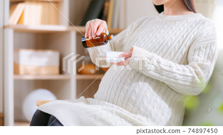 Pregnant woman dripping oil on cotton Aroma aromatic bath Skin care 16: 9 74897450