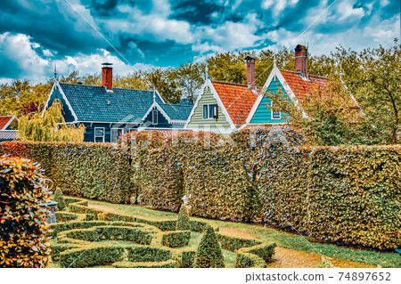 Typical, authentic village with cozy houses of the countryside in the Netherlands. Typical, authentic village with cozy houses of the countryside in the Netherlands. 74897652