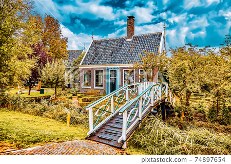 Typical, authentic village with cozy houses of the countryside in the Netherlands. Typical, authentic village with cozy houses of the countryside in the Netherlands. 74897654