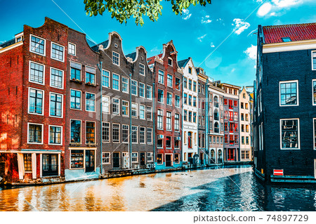Beautiful views of the streets, ancient buildings, people, embankments of Amsterdam - also call "Venice in the North". Netherlands Beautiful views of the streets, ancient buildings, people, embankments of Amsterdam - also call "Venice in the North". Netherlands 74897729