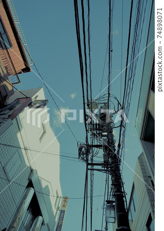 Utility poles in the blue sky and alleys Utility poles in the blue sky and alleys 74898071