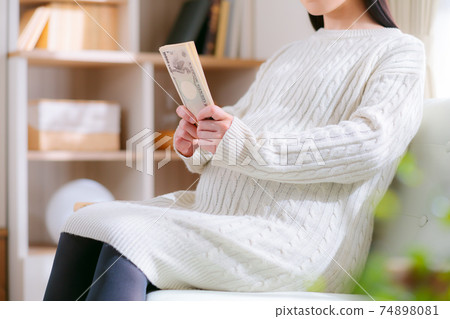 Pregnant woman preparing money Pregnant woman preparing money 74898081