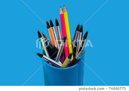 pens and pencils lying in a blue penholder 74898775
