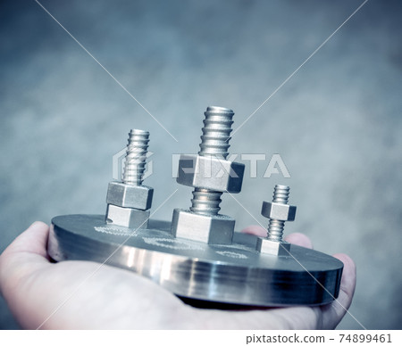 Man is holding object printed on metal 3d printer. Man is holding object printed on metal 3d printer. 74899461