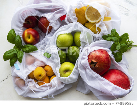 Mesh shopping bags with organic fruits  74899583