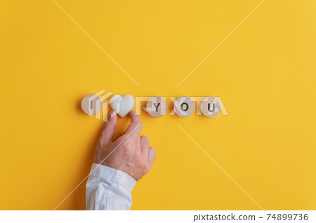 Male hand making an I love you sign Male hand making an I love you sign 74899736