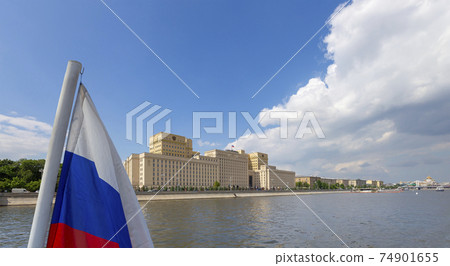 Russia flag and Main Building of the Ministry of Defence of the Russian Federation -- is the governing body of the Russian Armed Forces. Moscow, Russia 74901655