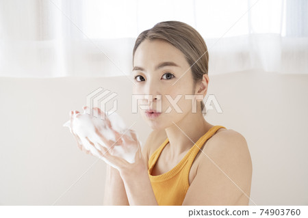 Women with facial cleansing Women with facial cleansing 74903760