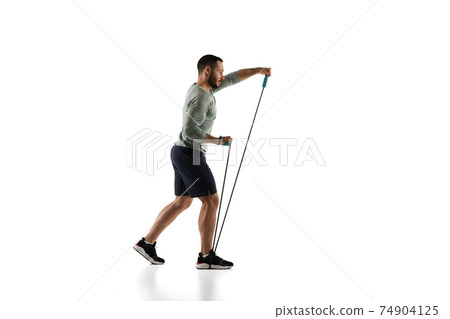 Young caucasian male model in action, motion isolated on white background. Concept of sport, movement, energy and dynamic, healthy lifestyle. Training, practicing. Young caucasian male model in action, motion isolated on white background. Concept of sport, movement, energy and dynamic, healthy lifestyle. Training, practicing. 74904125