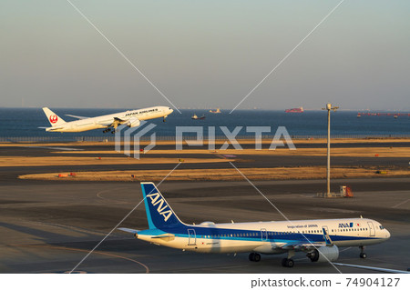 Airport at dusk, airplane taking off, Ota-ku, Tokyo Airport at dusk, airplane taking off, Ota-ku, Tokyo 74904127