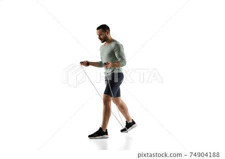 Young caucasian male model in action, motion isolated on white background. Concept of sport, movement, energy and dynamic, healthy lifestyle. Training, practicing. Young caucasian male model in action, motion isolated on white background. Concept of sport, movement, energy and dynamic, healthy lifestyle. Training, practicing. 74904188