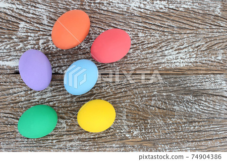 Easter eggs on wooden background with space Easter eggs on wooden background with space 74904386