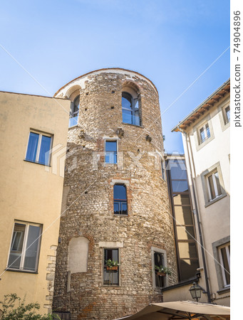 A street in Florence, Italy, with an old round brick house clenched with modern houses A street in Florence, Italy, with an old round brick house clenched with modern houses 74904896