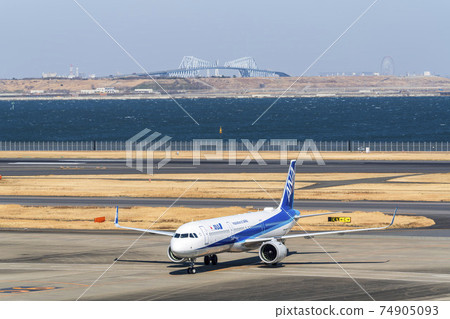 Airport scenery: Taxiing airplane and Tokyo Gate Bridge, Ota-ku, Tokyo 74905093