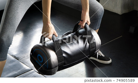 sport, fitness, weightlifting and training concept - crop image of people with dumbbells' bag and heart-rate trackers exercising in gym sport, fitness, weightlifting and training concept - crop image of people with dumbbells' bag and heart-rate trackers exercising in gym 74905589
