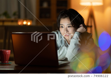 看一台計算機的少婦在客廳在晚上 74906122