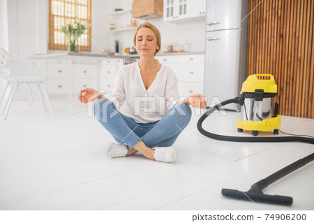 Pretty woman in lotus position after cleaning Pretty woman in lotus position after cleaning 74906200