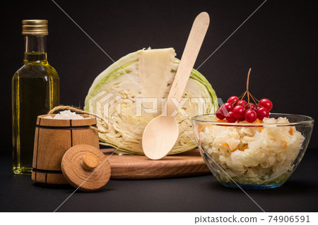 Fermented cabbage with herbs and spices in glass bowl on the black background 74906591
