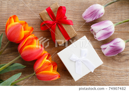 Gift boxes with ribbons on wooden boards. Gift boxes with ribbons on wooden boards. 74907482