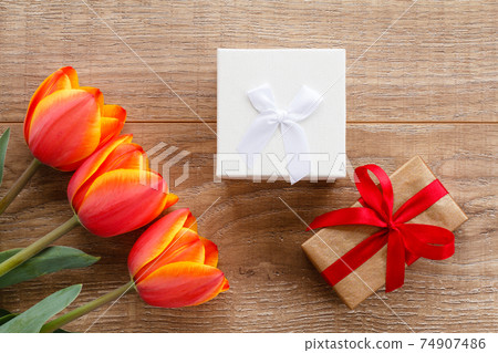 Gift boxes with ribbons on wooden boards. Gift boxes with ribbons on wooden boards. 74907486