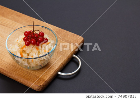 Fermented cabbage with herbs and spices in glass bowl on the black background 74907815