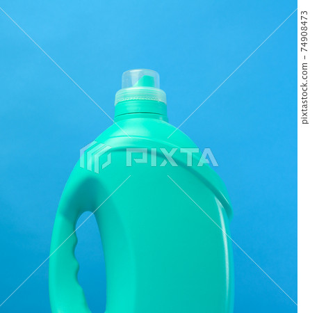 green plastic bottle with detergents on blue background green plastic bottle with detergents on blue background 74908473