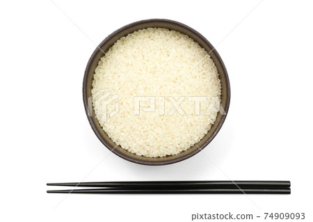 White rice and chopsticks in a bowl White rice and chopsticks in a bowl 74909093